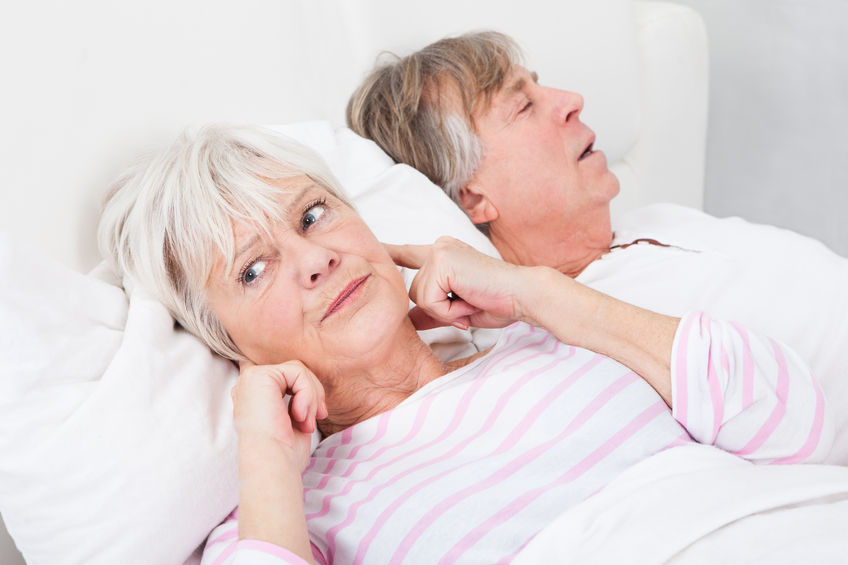 Senior woman awaken by husband snoring