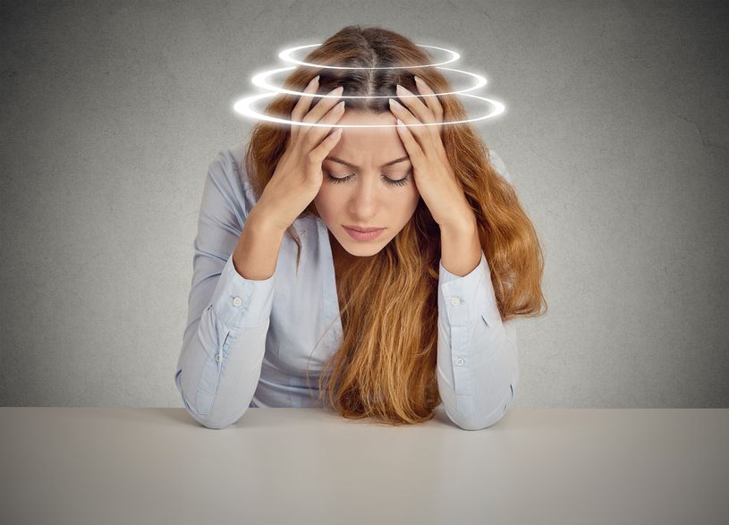 Woman with vertigo, suffering from dizziness
